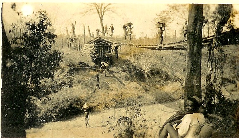 Carriers crossing the suspension bridge over the Lutsimbwe with loads